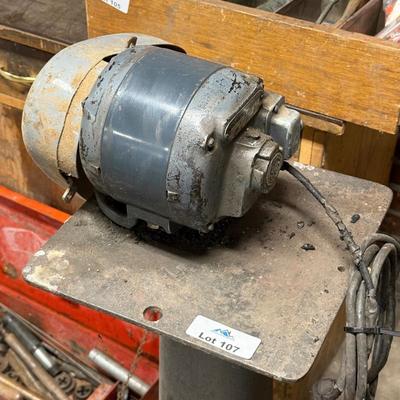 Metal stand with old motor mounted on top