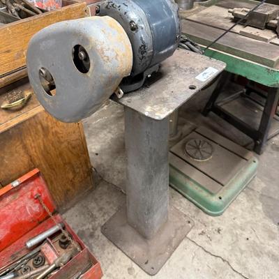 Metal stand with old motor mounted on top