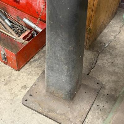 Metal stand with old motor mounted on top