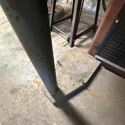 Metal stand with wood roll of thin metal