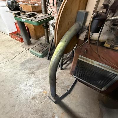 Metal stand with wood roll of thin metal