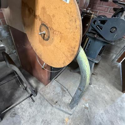 Metal stand with wood roll of thin metal