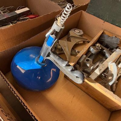 Box with 2 angle clamps/drain snake/chalk line & misc. machine parts