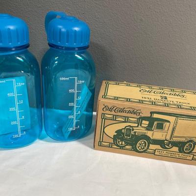 2 water bottles and collectors car