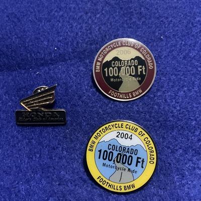 2004 and 2006 100,000 ft motorcycle ride and Honda pin.