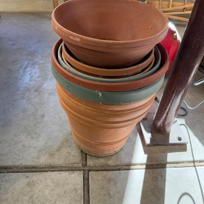 2 Large Plastic Flower pots and several Saucers
