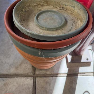 2 Large Plastic Flower pots and several Saucers