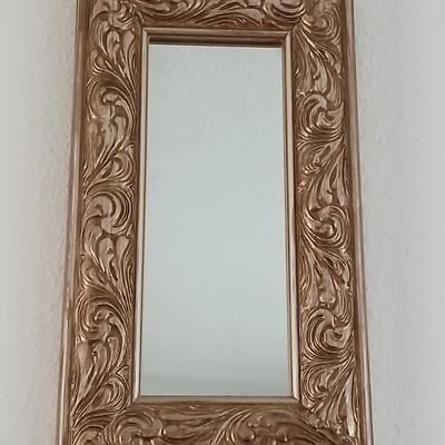 Grouping of mirrored wall hangings and a picture frame