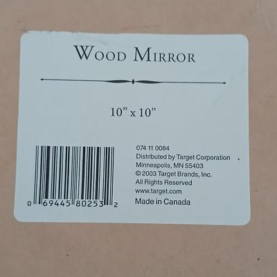 Grouping of mirrored wall hangings and a picture frame