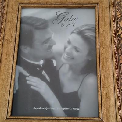 Grouping of mirrored wall hangings and a picture frame