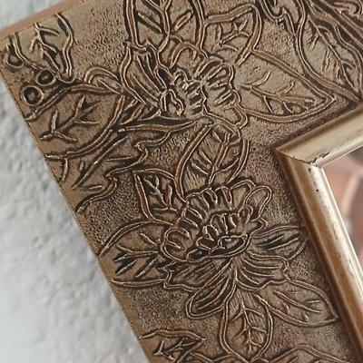 Grouping of mirrored wall hangings and a picture frame