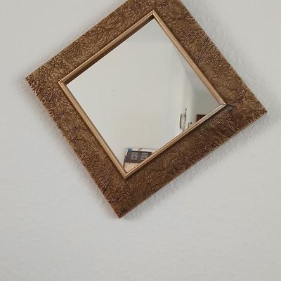 Grouping of mirrored wall hangings and a picture frame