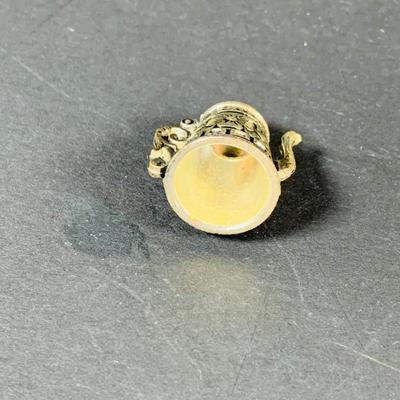 LOT:53: Medieval Coat of Arms, Don Quixote Metal Statue and Metal Ashtray, Miniature Alter Cross, Mini Brass Mortar and Pestle and a Thimble