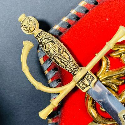 LOT:53: Medieval Coat of Arms, Don Quixote Metal Statue and Metal Ashtray, Miniature Alter Cross, Mini Brass Mortar and Pestle and a Thimble