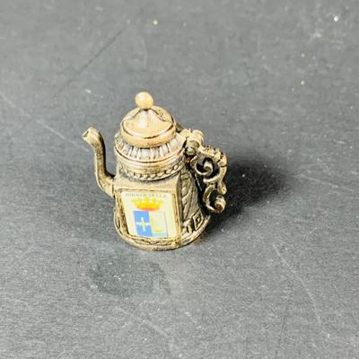 LOT:53: Medieval Coat of Arms, Don Quixote Metal Statue and Metal Ashtray, Miniature Alter Cross, Mini Brass Mortar and Pestle and a Thimble