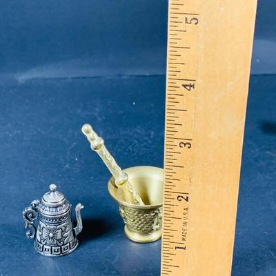 LOT:53: Medieval Coat of Arms, Don Quixote Metal Statue and Metal Ashtray, Miniature Alter Cross, Mini Brass Mortar and Pestle and a Thimble