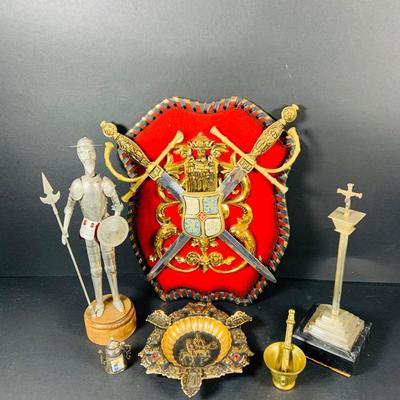 LOT:53: Medieval Coat of Arms, Don Quixote Metal Statue and Metal Ashtray, Miniature Alter Cross, Mini Brass Mortar and Pestle and a Thimble