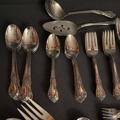 LOT 172: Distinction Deluxe Stainless by Oneida, 7 pc Place Setting, Service for 12 & 5 Serving Pieces