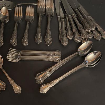 LOT 172: Distinction Deluxe Stainless by Oneida, 7 pc Place Setting, Service for 12 & 5 Serving Pieces