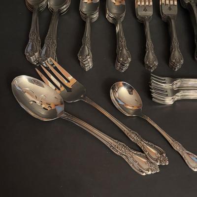 LOT 172: Distinction Deluxe Stainless by Oneida, 7 pc Place Setting, Service for 12 & 5 Serving Pieces