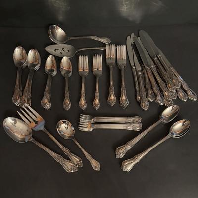 LOT 172: Distinction Deluxe Stainless by Oneida, 7 pc Place Setting, Service for 12 & 5 Serving Pieces
