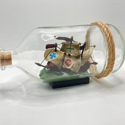LOT 177: Explorer’s Collection - Santa Maria Ship Radio, Cork Art, Ship in Glass Bottle, Brass Whale, Decorative Desk Globe and More