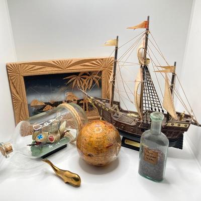 LOT 177: Explorer’s Collection - Santa Maria Ship Radio, Cork Art, Ship in Glass Bottle, Brass Whale, Decorative Desk Globe and More