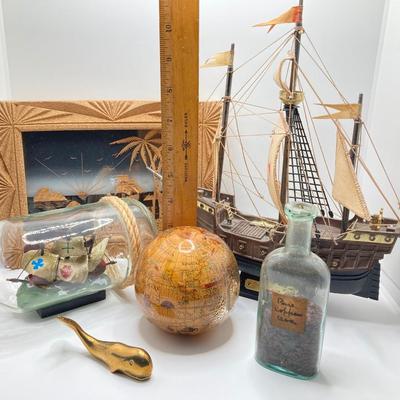 LOT 177: Explorer’s Collection - Santa Maria Ship Radio, Cork Art, Ship in Glass Bottle, Brass Whale, Decorative Desk Globe and More