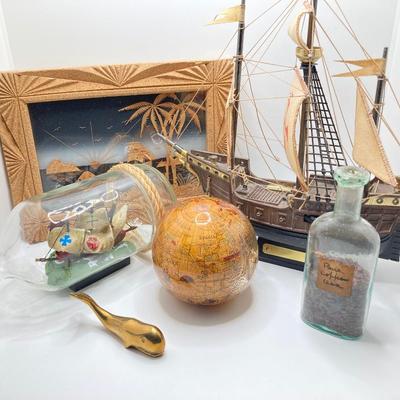 LOT 177: Explorer’s Collection - Santa Maria Ship Radio, Cork Art, Ship in Glass Bottle, Brass Whale, Decorative Desk Globe and More