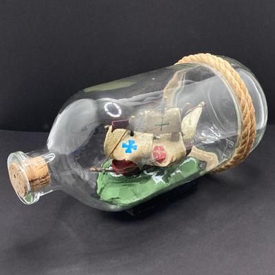 LOT 177: Explorer’s Collection - Santa Maria Ship Radio, Cork Art, Ship in Glass Bottle, Brass Whale, Decorative Desk Globe and More