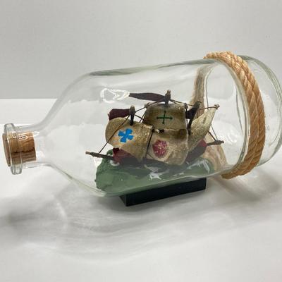 LOT 177: Explorer’s Collection - Santa Maria Ship Radio, Cork Art, Ship in Glass Bottle, Brass Whale, Decorative Desk Globe and More