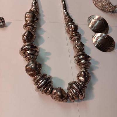 CHARM BRACELET AND AN ASSORTMENT OF SILVER-TONE JEWELRY
