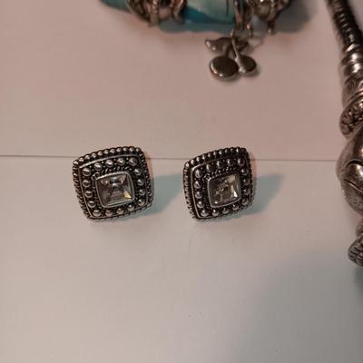 CHARM BRACELET AND AN ASSORTMENT OF SILVER-TONE JEWELRY