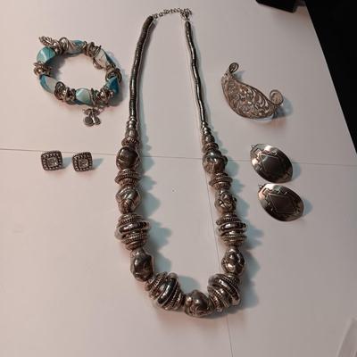 CHARM BRACELET AND AN ASSORTMENT OF SILVER-TONE JEWELRY