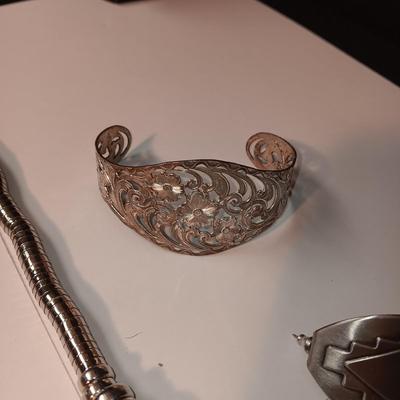 CHARM BRACELET AND AN ASSORTMENT OF SILVER-TONE JEWELRY