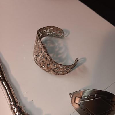 CHARM BRACELET AND AN ASSORTMENT OF SILVER-TONE JEWELRY