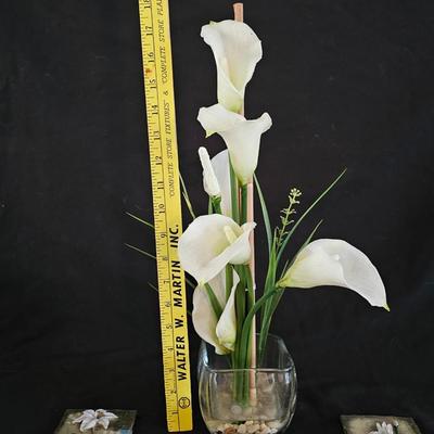 Faux cala lilies in a vase with four floral wall hanging plaques