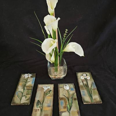 Faux cala lilies in a vase with four floral wall hanging plaques