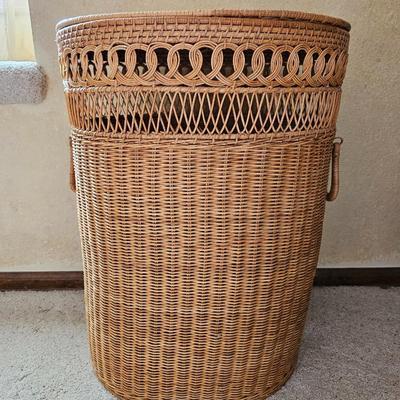 Wicker laundry hamper with wooden clothes hangers