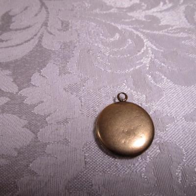 Vintage locket with engraved E on front