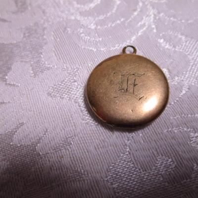 Vintage locket with engraved E on front