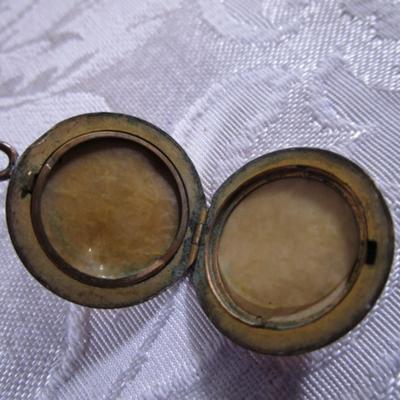 Vintage locket with engraved E on front
