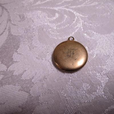 Vintage locket with engraved E on front