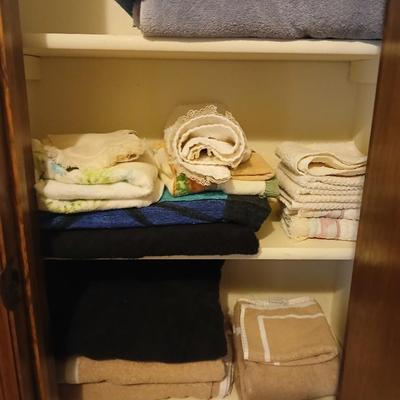 Bath towels, hand towels, bath trash can and a travel alarm clock