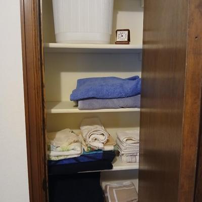 Bath towels, hand towels, bath trash can and a travel alarm clock