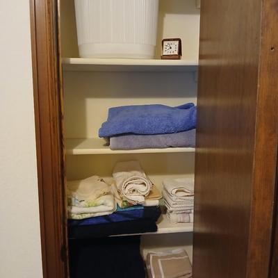 Bath towels, hand towels, bath trash can and a travel alarm clock