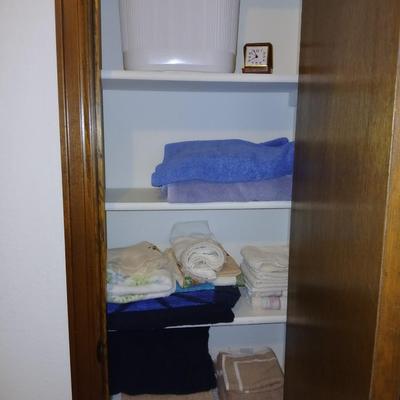 Bath towels, hand towels, bath trash can and a travel alarm clock