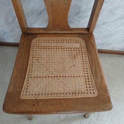 Vintage wicker seat dining room chair and an Afghan shawl