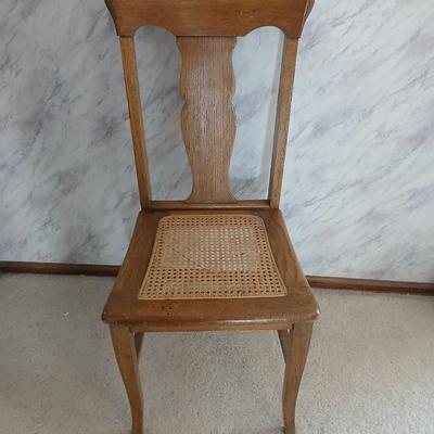 Vintage wicker seat dining room chair and an Afghan shawl