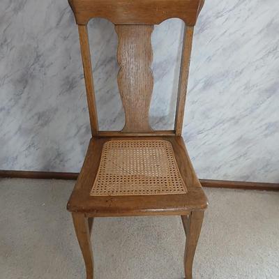Vintage wicker seat dining room chair and an Afghan shawl